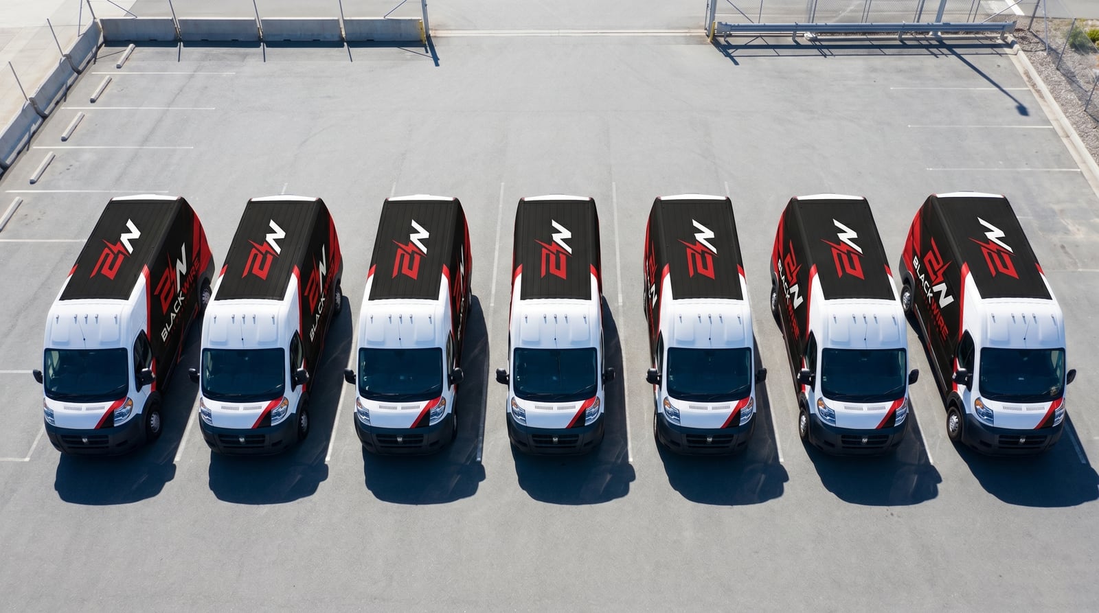 Aerial view of the Blackwire Electricians van fleet parked in a row
